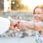 Woman holding man's hand