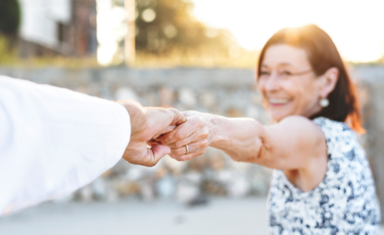 Woman holding man's hand