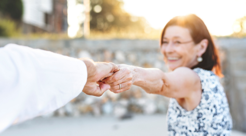 Woman holding man's hand